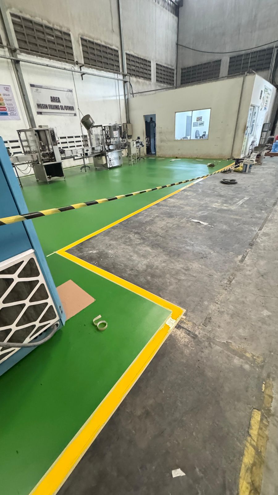 Marking line kuning membentuk batas area produksi pada lantai epoxy hijau