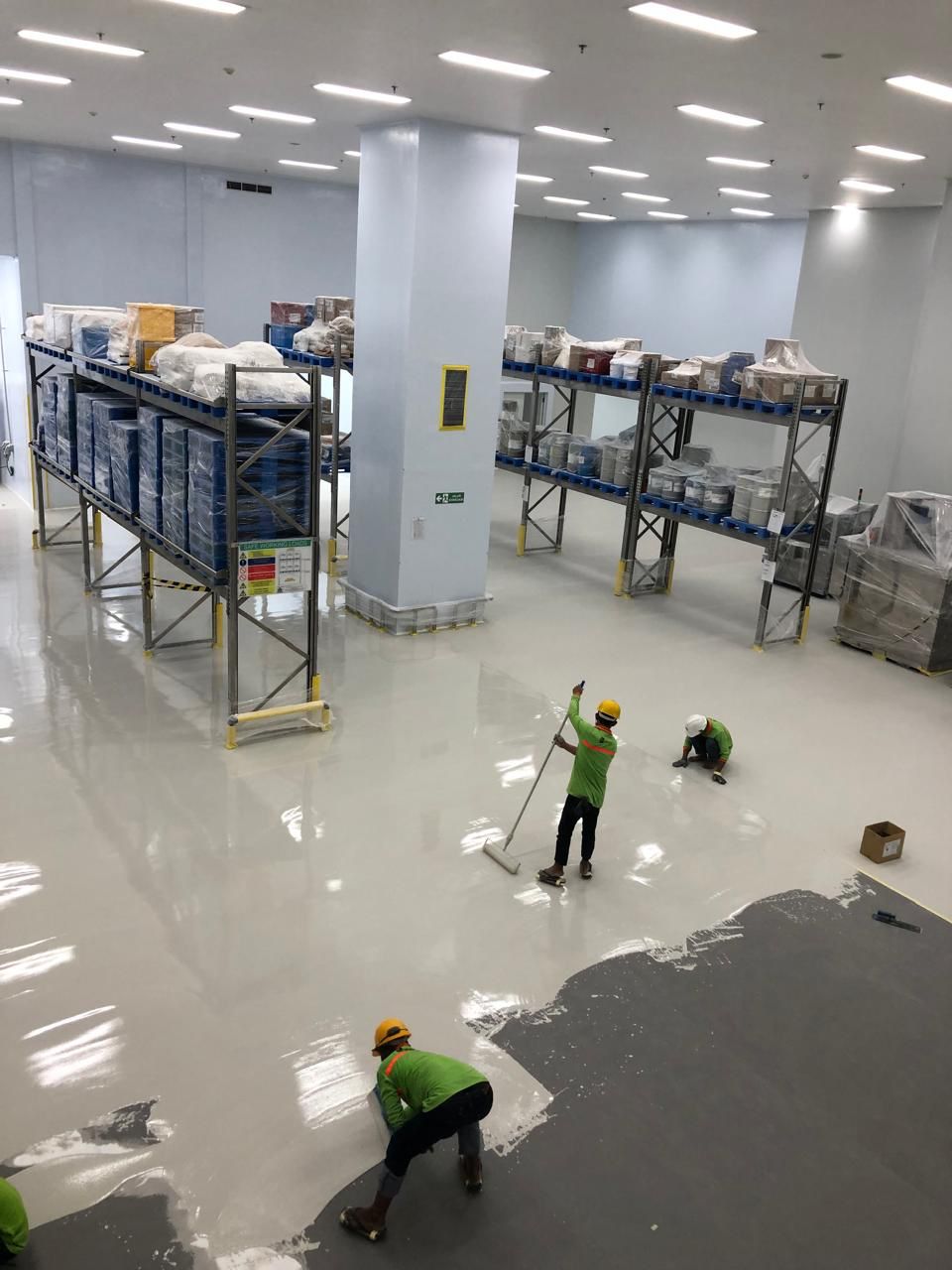 Aplikasi epoxy self leveling pada area gudang dengan kontrol ketebalan dan arah aplikasi
